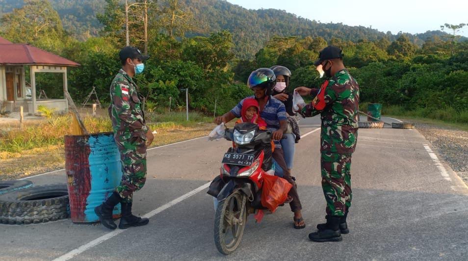 Personel Satgas Pamtas Yonif 642 Bagikan Takjil saat Sweeping