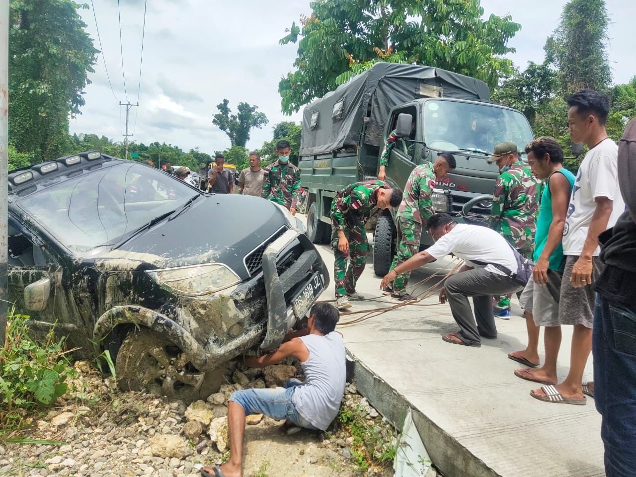 Satgas Pamtas Yonif 131/Brs Evakuasi Mobil Warga Terguling
